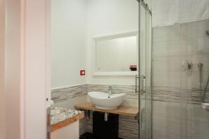 a bathroom with a sink and a glass shower at Le Meraviglie della Sicilia in Palermo +46 photos