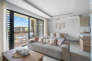 a living room with a couch and a table at Indian Summer by IHR in Flic-en-Flac