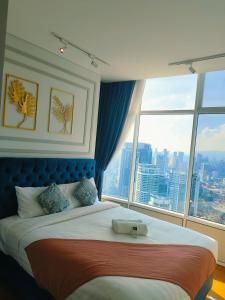 a bedroom with a large bed with a large window at Sky Suites klcc in Kuala Lumpur +72 photos