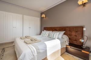 a bedroom with a large bed with a wooden headboard at Villa Felicity in Porches +31 photos