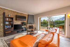 a living room with a couch and a large window at Villa Felicity in Porches