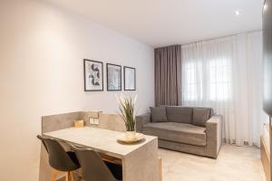 a living room with a table and a couch at Ark Urban Living in Kozani