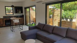 a living room with a couch and a table at Dépendance type t3 in Seignosse