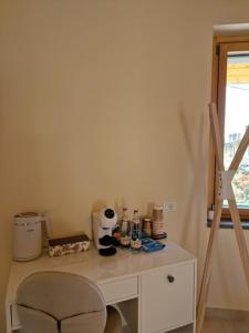 a white desk with a chair next to a window at La Corte dell'Angelo - Riccardo Room in Orio al Serio +3 photos