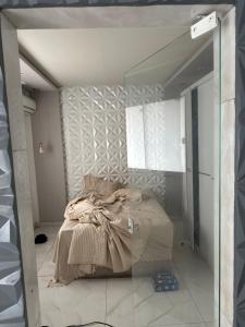 a bedroom with a bed and a mirror at Casa do love in Salvador