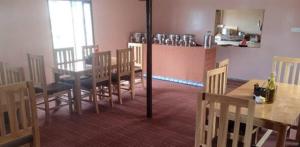 a kitchen and dining room with a table and chairs at Tsomoriri Inn Cottages in Karzok Gömpa +17 photos