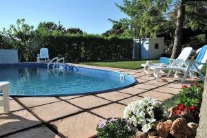 a swimming pool with two lawn chairs and adozen at Villa Vallereale giardino e piscina uso esclusivo in Itri