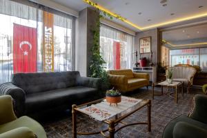 a living room with a couch and a table at Baykara Hotel in Konya