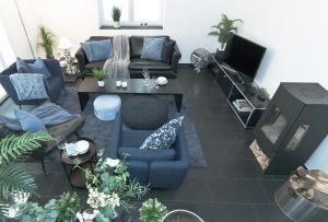 a living room with a couch and a tv at Ferienhaus Ostseetraum Langholz in Waabs