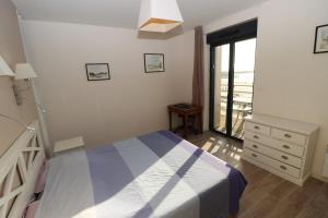 a bedroom with a bed and a dresser and a window at Le Dream by Tranquil at Home - Parking, Piscine, Plage et Wifi in Pornichet +7 photos