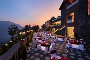 a long row of tables and chairs on a building at Deventure Shimla Hills in Kandāghāt