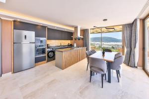 eine Küche und ein Esszimmer mit Tisch und Stühlen in der Unterkunft 3 Bedroom Luxury Villa, Private Pool, Near Kalkan in Kaş