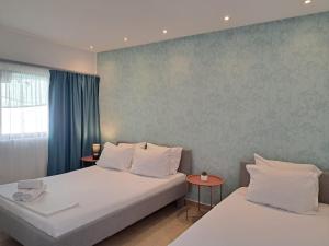 a bedroom with two beds and a window at Garden Apartments in Ulcinj