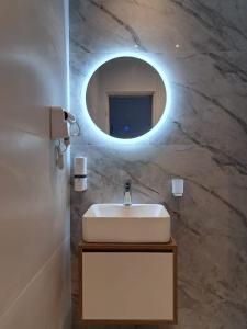 a bathroom with a sink and a mirror at Garden Apartments in Ulcinj +37 photos
