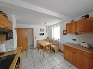 a kitchen with a table and a small table in it at Apartment O1 - Gut ausgestattete 3-Zimmer Wohnung 78qm für 1-3 Personen 1xDZ 1xEZ in Gravenwerth +15 photos