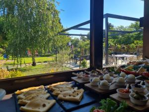a buffet of food on a table next to a window at Garden Apartments in Ulcinj