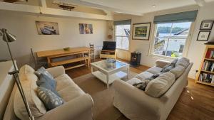 a living room with two couches and a television at Workshop in Saint Mawes