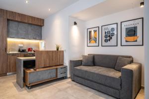 a living room with a couch and a kitchen at Ark Urban Living in Kozani