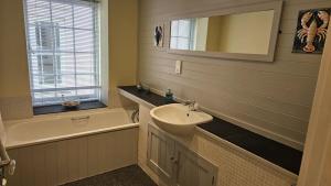 a bathroom with a sink and a bath tub at Charlies in Saint Mawes +44 photos