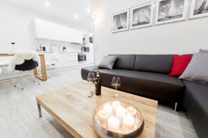 a living room with a couch and a table with candles at Treibgut in Norddeich +14 photos
