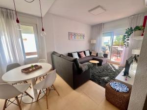 a living room with a couch and a table at Condado de Alhama PENTHOUSE SV11 in Alhama de Murcia