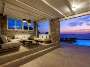 a living room with a view of the ocean at Villa Tavani Agios Ioannis Mykonos in Agios Ioannis Mykonos