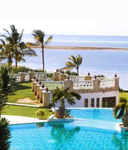 a resort with a swimming pool in front of the ocean at Hapisaro in Mombasa