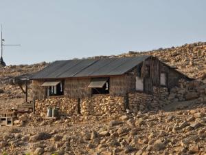 a stone house on a rocky hillside at Succah in the Desert in Mitzpe Ramon