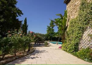 a path leading to a swimming pool with plants at Le mas du murier - Portes de Provence - Mas de 1890 rénové avec climatisation in Loriol-sur-Drôme