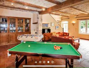 a large living room with a pool table at Le mas du murier - Portes de Provence - Mas de 1890 rénové avec climatisation in Loriol-sur-Drôme