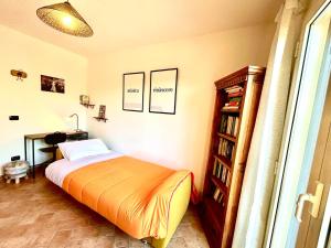 a bedroom with a bed and a book shelf at Tuffo Antico in Vasanello +9 photos