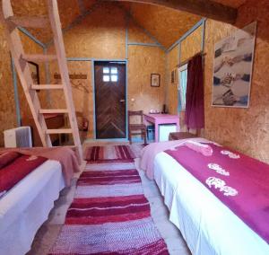 a room with three beds and a ladder at Oandu Camping in Oandu