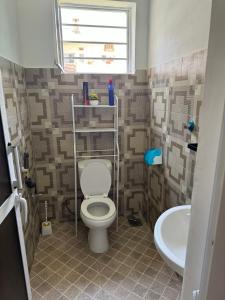 a bathroom with a toilet and a sink at Town Retreat Moshi in Moshi +50 photos