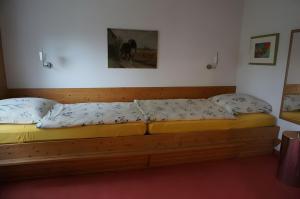 a bed in a room with two pillows on it at Ferienwohnung am Naturgarten in Waldbröl