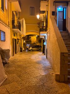 an alley in an old town at night at Bari annette room in Bari