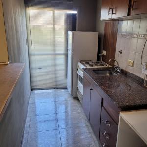 a kitchen with a sink and a refrigerator at Dpto Centeno Centrico 3 B in Santa Rosa