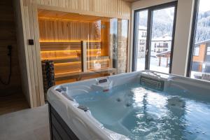 a large tub in a bathroom with a large window at Chalet Pamporovo in Pamporovo +96 photos