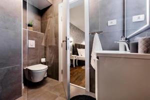 a bathroom with a toilet and a sink at Deluxe Apartments A&A - 2 in Rovinj +64 photos