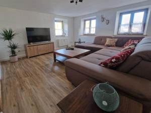 a living room with a couch and a flat screen tv at Ferienwohnung Alpenhirsch Schwangau in Schwangau