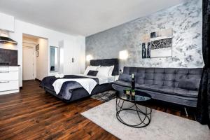 a bedroom with a bed and a couch at Deluxe Apartments A&A - 2 in Rovinj