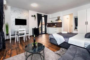 a hotel room with a bed and a table at Deluxe Apartments A&A - 2 in Rovinj