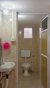 a bathroom with a toilet and a sink at Radha Krishna Villa in Belkāde