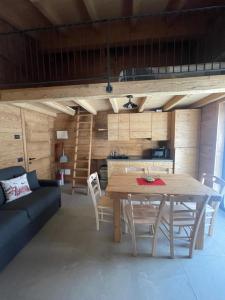 a kitchen and dining room with a wooden table and chairs at Sabbionaccio Apartments & Spa in Chiesa in Valmalenco +112 photos