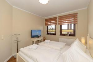 Postel nebo postele na pokoji v ubytování Urlaubstraeume-am-Meer-Wohnung-5-6-656