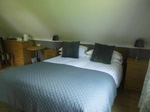 Tempat tidur dalam kamar di Eas Dun Lodge