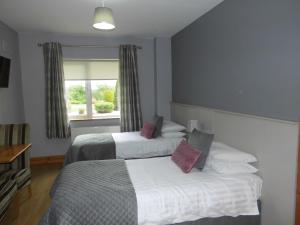 Tempat tidur dalam kamar di Eas Dun Lodge
