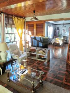 Una sala de estar con un sofá y un televisor. en Chalet céntrico costero en Gijón, en Gijón 27 fotos más