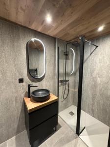 a bathroom with a sink and a shower at Chalet Jean (Coeur de Morzine) Jacuzzi & Sauna in Morzine +50 photos