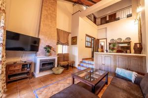 ein Wohnzimmer mit Couch und Kamin in der Unterkunft Casa el Rincón del Lago Alojamiento Rural in Córdoba