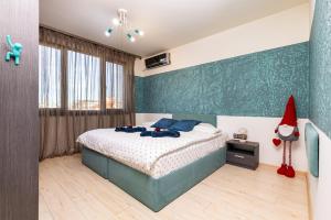 a bedroom with a bed with a santa hat on the wall at Nikolaos Apartment by Flat Mаnager in Plovdiv